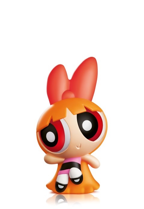 Small toy figure of a cartoon character with large red bow, orange dress, and big eyes, on plain white background
