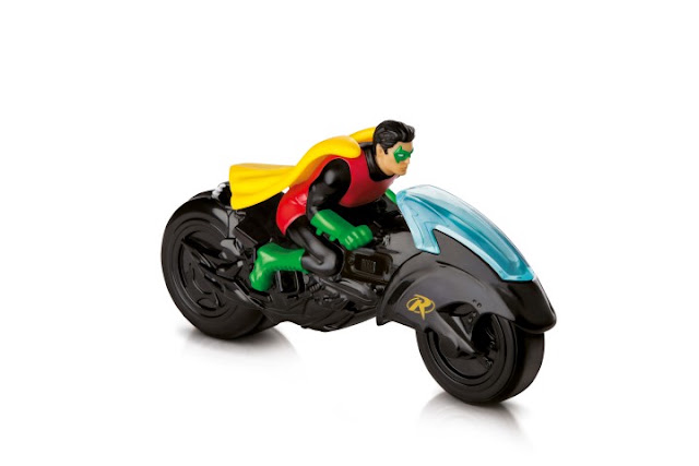 Toy figure riding a black motorcycle-style vehicle, figure wearing red, green, and yellow costume with cape, on white background